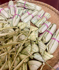 A beautifully arranged assortment of traditional Malay rice dumplings known as Ketupat, wrapped...