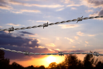 Barbed wire against the sunset