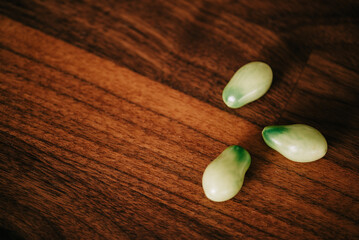 Green Roma tomatoes from the garden arranged on wooden surface