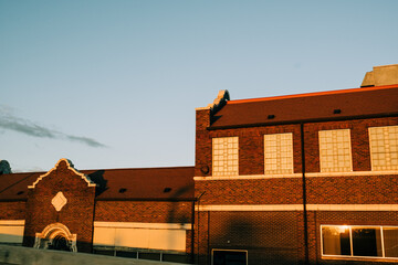 Sunset light casts warm glow on historic brick building