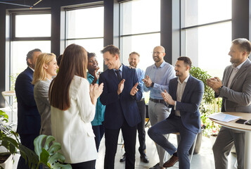 Business team applauding and celebrates success during a meeting in the office. Collaboration,...
