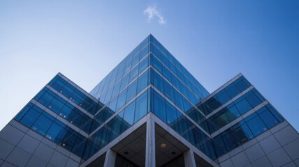Obraz premium Modern glass and steel office building, symmetrical design, bathed in midday light, showcasing sleek architecture and urban professionalism.