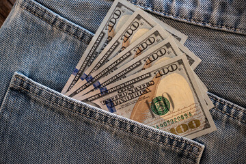 Cash tucked in a denim pocket during a casual day