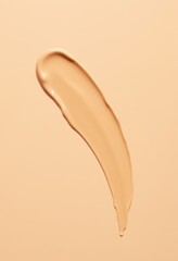 Fototapeta premium a close up of a liquid foundation on a beige background
