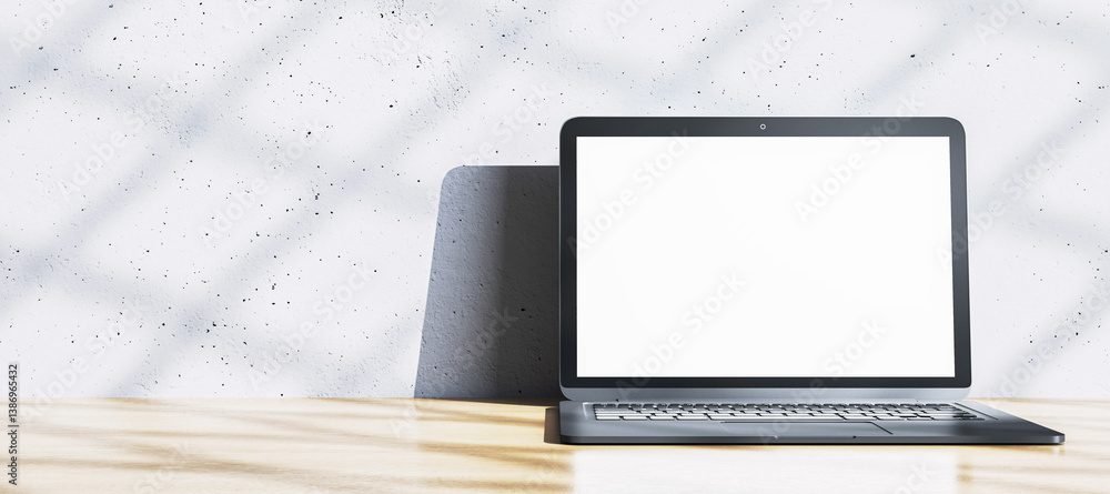 Poster blank laptop screen on wooden desk in modern interior with textured white wall and natural light sha