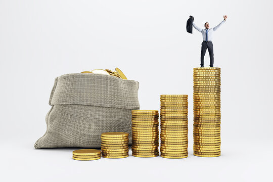 Businessman standing victoriously on top of gold coin stacks symbolizing financial success and investment growth on light background.