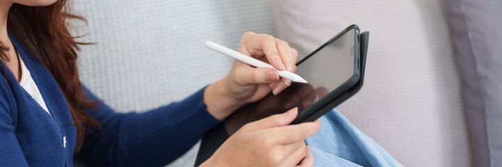 Digital Signature: A person is shown engrossed in using a stylus to sign a digital document on a...