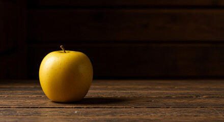 Golden Delicious Apple on Rustic Wooden Table – Cozy Cabin Minimalist Scene