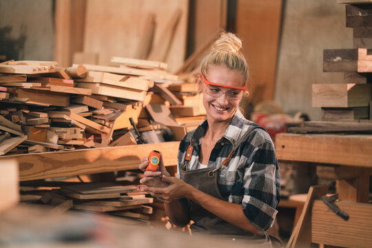 Female Carpenter Working in Shop, Skilled Professional Using Tools Equipment to Craft Wooden Furniture and Timber Pieces, Expertise in Woodworking Industry Craftsmanship