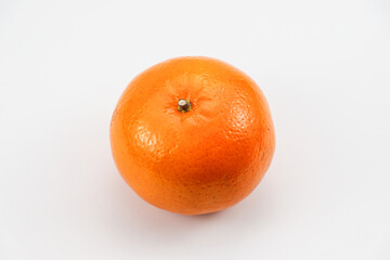 Bright orange tangerine centered on white surface