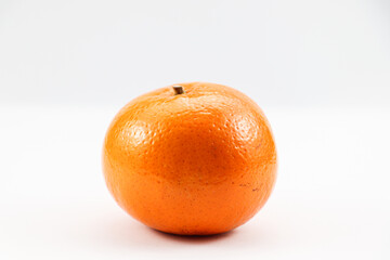 Juicy tangerine with bumpy skin side view