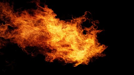 Fototapeta premium Bright orange flames dancing against a dark backdrop.