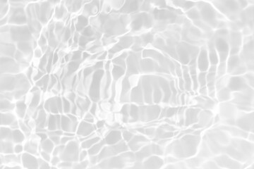 Obraz premium White water with ripples on the surface. Defocus blurred transparent white colored clear calm water surface texture with splashes and bubbles. Water waves with shining pattern texture background.
