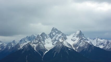 Obraz premium Snowy Mountain Peaks Under Overcast Sky