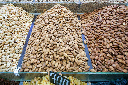 Peeled almonds, raw and roasted, piled up in a market for sale. Close-up of peeled almonds.