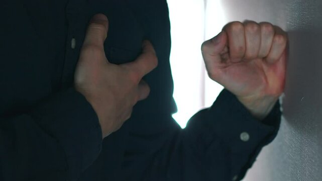 Severe heart pain in a man in a blue shirt.
The man suffers from pain in the heart and chest.
Heart pain and tachycardia