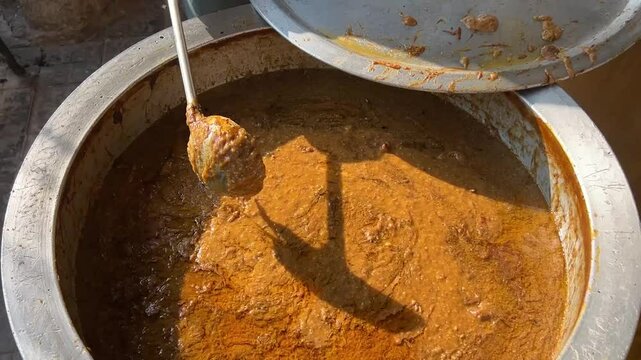 Thick Hyderabadi Haleem being prepared outside in a container in Kolkata.