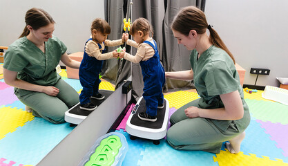 Whole body vibration therapy for girl with disabilities together with physical therapist in...