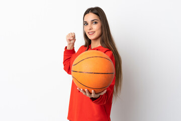 Young caucasian woman isolated on white background playing basketball