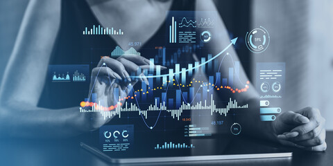 Businesswoman analyzing financial data on a digital tablet.