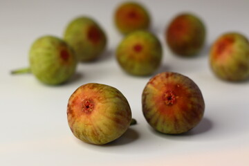 Fresh figs on a white background, showing soft texture and rich color