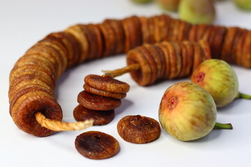 Dried and fresh figs on a white background, highlighting their color and texture