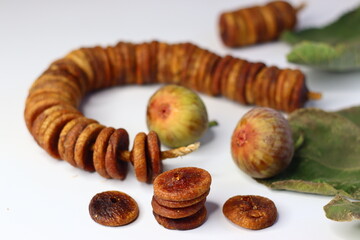 Dried and fresh figs on a white background, highlighting their color and texture