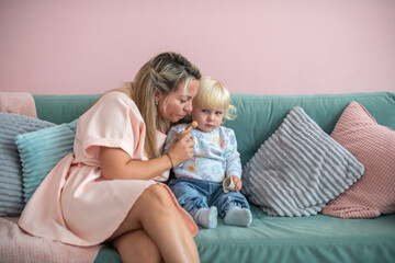 Happy mother and baby have fun at home. Smile, happiness and parental care in the house with mother's love and bonding with the baby.