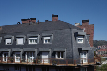 Workers on the roof of a building