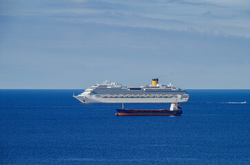 Mega family cruiseship cruise ship liner Favolosa and bunker ship anchored offshore of...
