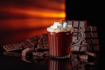 Hot chocolate with mini marshmallow in a glass mug.