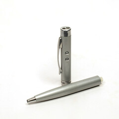 Ballpoint pen in a silver metal case with a built-in LED flashlight and laser pointer, disassembled into two parts. Isolate on white.