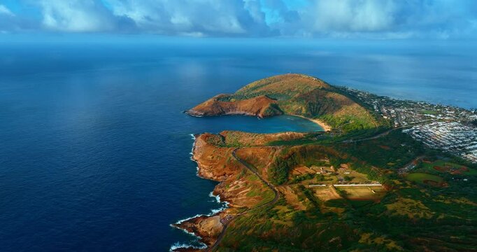 Beautiful panorama of a rocky island with inhabited area. Azure waterscape of the Pacific Ocean surrounding the east of Island Oahu, Hawaii, USA. Aerial perspective.