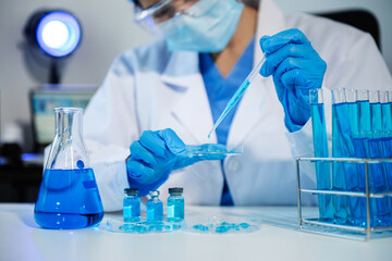 Scientist mixing chemical liquids in the chemistry lab. Researcher working in laboratory.