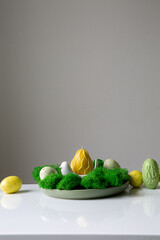 A collection of painted easter eggs celebrating a Happy Easter on a spring day with green grass with copy space.