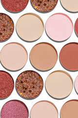 Eyeshadow palette, mix of matte and shimmer shades in pink, nude, red, brown hues. Minimal top view pattern for beauty, makeup, cosmetics themes, Vivid colored swatches eyeshade refills circle shape