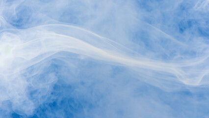Obraz premium Abstract Smoke in Azure Sky: The photograph showcases a delicate dance of white smoke gracefully billowing against a vibrant, cloud-filled azure backdrop.