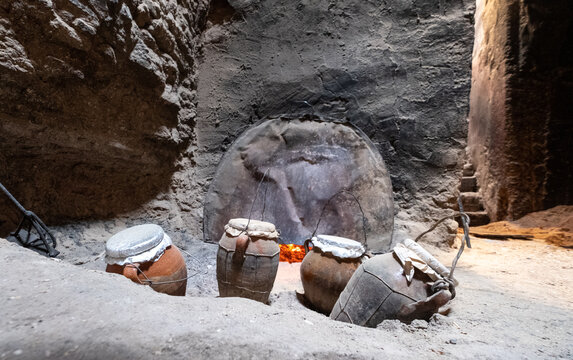 Tanjia cooking vessels deep in ash, heated by the adjacent Hamman hot baths. The food in the clay tangia vessels cooks slowly over many hours. Photographed in the old town medina in Marrakech, Morocco