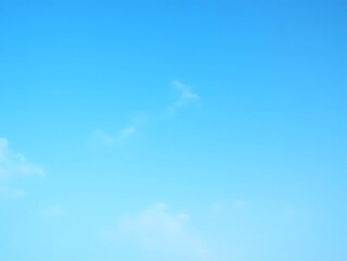 Serene Blue Sky with Wispy Clouds and Contrail