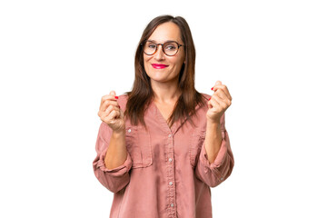 Middle-aged caucasian woman over isolated background making money gesture