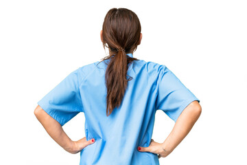 Middle-aged nurse woman over isolated background in back position