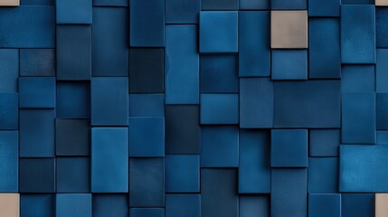 An arrangement of square and rectangular tiles in multiple shades of blue creates a modern textured wall, offering a visually striking backdrop.