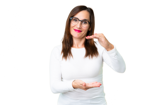 Middle age woman over isolated chroma key background holding copyspace imaginary on the palm to insert an ad