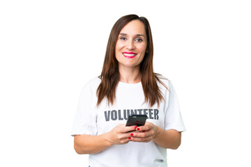 Middle age volunteer woman over isolated chroma key background sending a message with the mobile