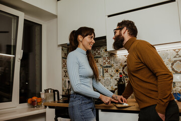 An elegant couple, around 35 years old, is enjoying a cozy evening together.