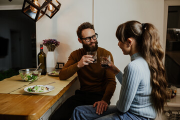An elegant couple, around 35 years old, is enjoying a cozy evening together.