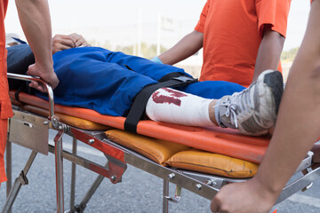 Paramedic, emergency, ambulance staff and medical help. Ambulance staff member assisting injured...