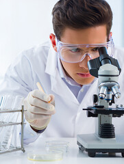 Scientist in lab with microscope