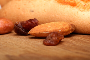 Obraz premium Almonds and dried fruits on wood