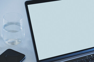 Close-up of a modern laptop with a blank light blue screen